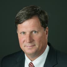 Portrait of Peter Brown, Senior Vice President & Chief Lending Officer of Magyar Bank, smiling warmly.